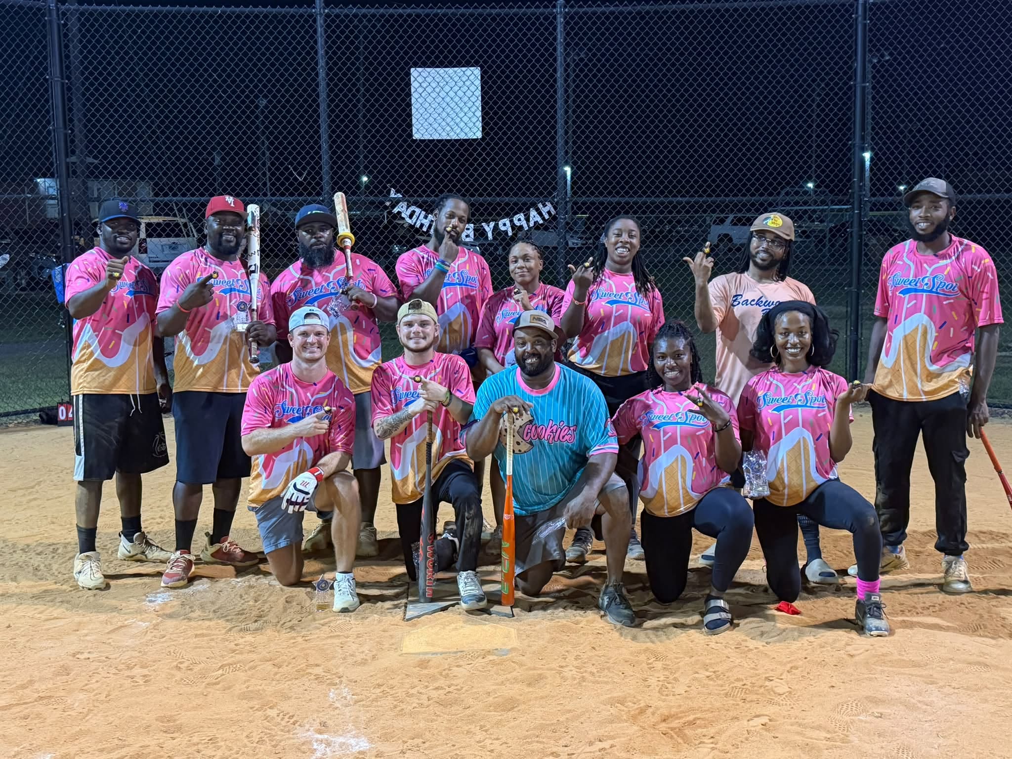 First-place season championship team celebrating on the softball field